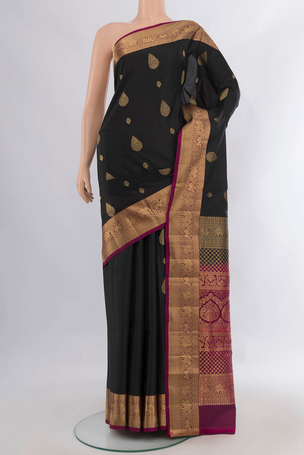 Pure Silk Black Soft Saree with Zari Butta on the body and Zari Border.  displayed on a mannequin