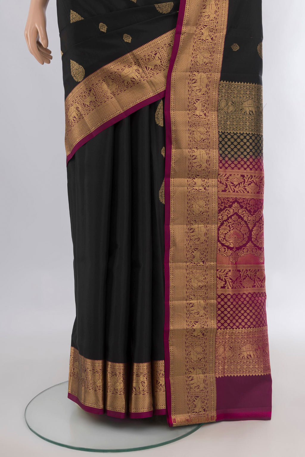 Pleats and pallu of Pure Silk Black Soft Saree with Zari Butta on the body and Zari Border. 
