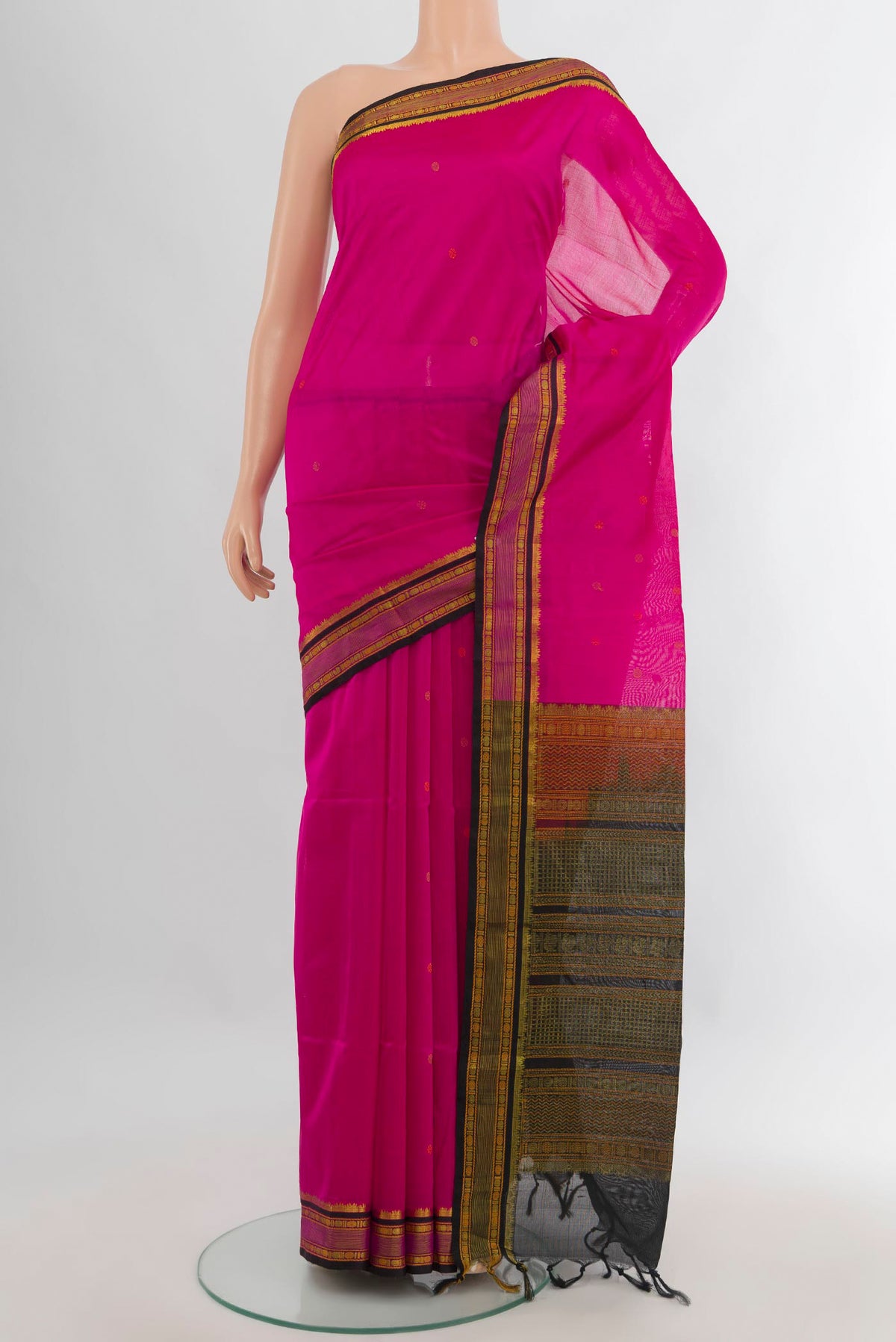 Rani Pink Silk Cotton Saree with Thread Butta on the body and Zari Border.  displayed on a mannequin