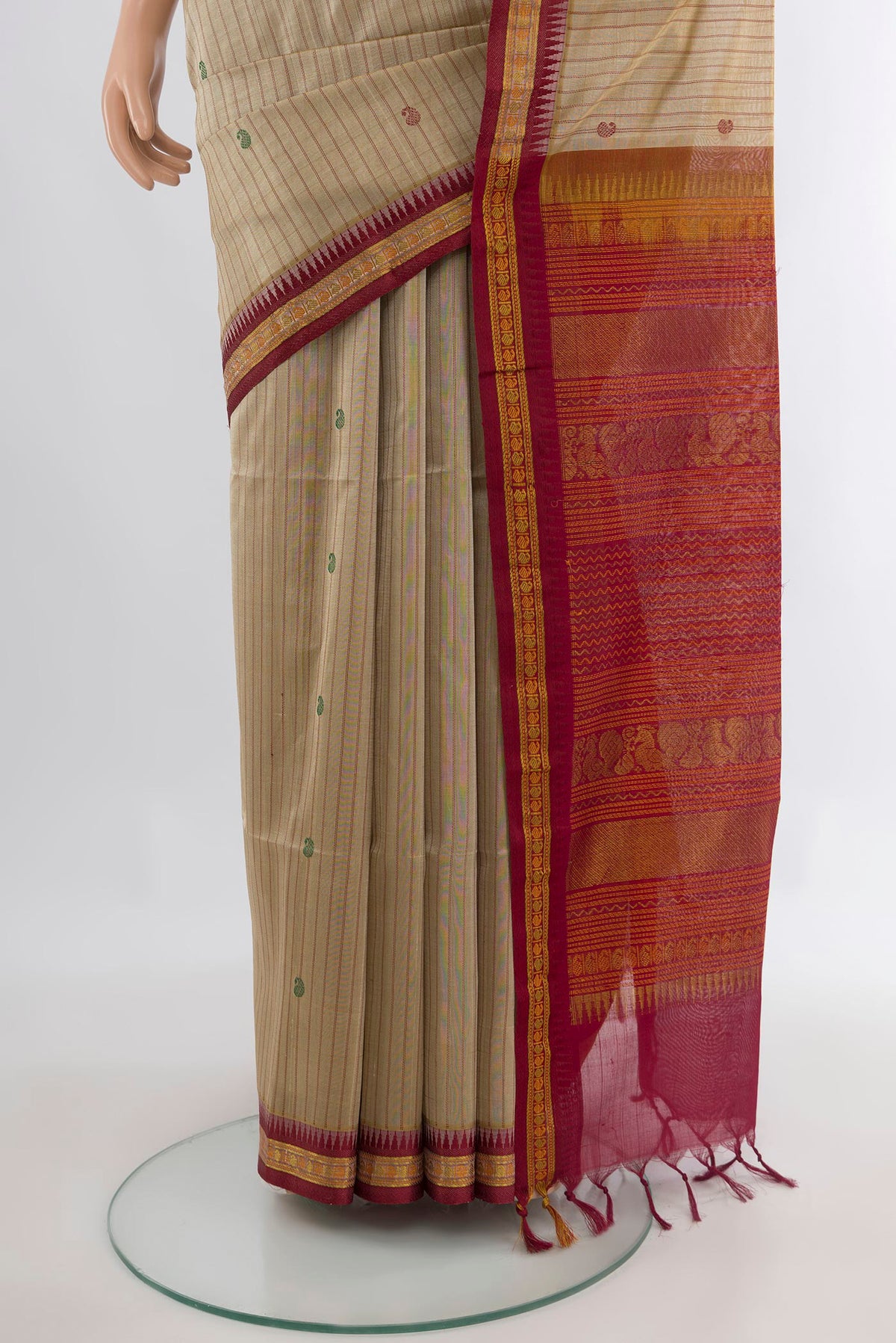 Pleats and pallu of Beige Silk Cotton Saree with Stripes on the body and Zari Border. 