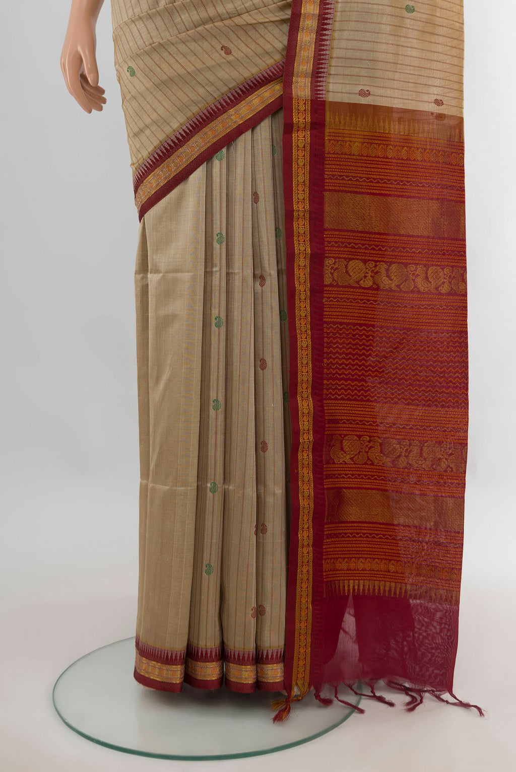 Pleats and pallu of Beige Silk Cotton Saree with Stripes on the body and Zari Border. 