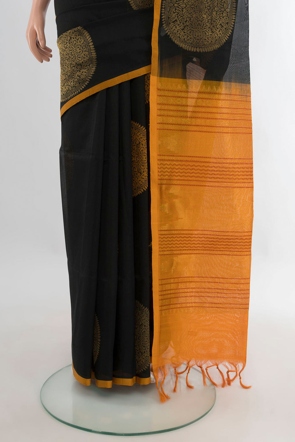 Pleats and pallu of Black Silk Cotton Saree with Zari And Thread Butta on the body and Plain Border. 