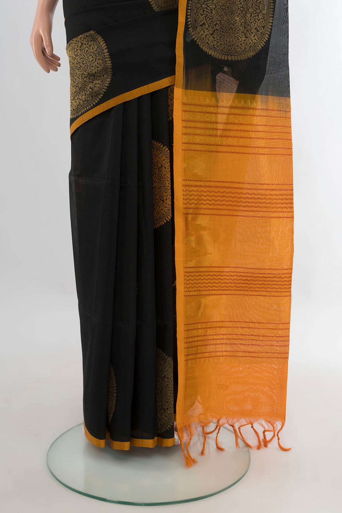 Pleats and pallu of Black Silk Cotton Saree with Zari And Thread Butta on the body and Plain Border. 