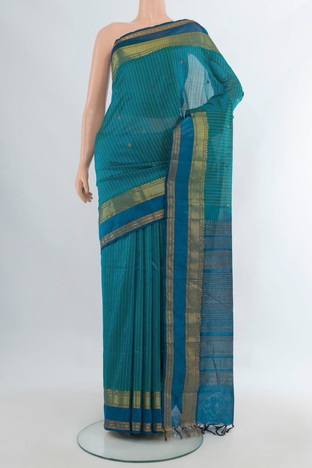 Sea Green Silk Cotton Saree with Thread Butta on the body and Zari Border.  displayed on a mannequin
