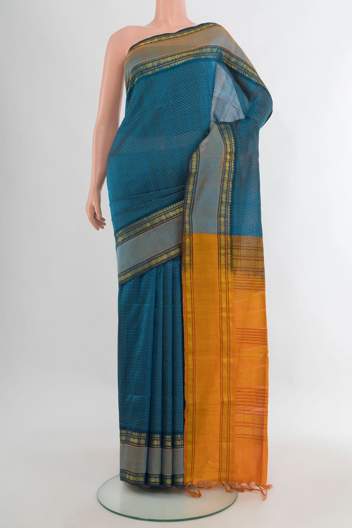 Peacock Blue Silk Cotton Saree with Checked design on the body and Zari Border.  displayed on a mannequin