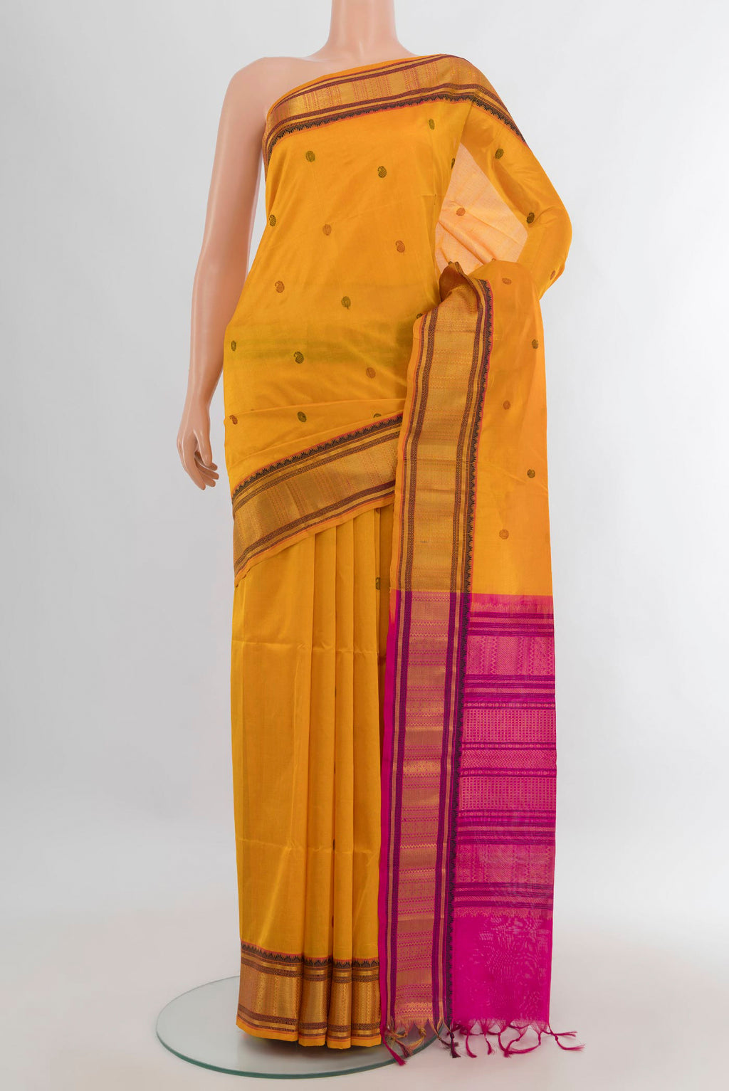 Yellow Silk Cotton Saree with Thread Butta on the body and Zari Border.  displayed on a mannequin