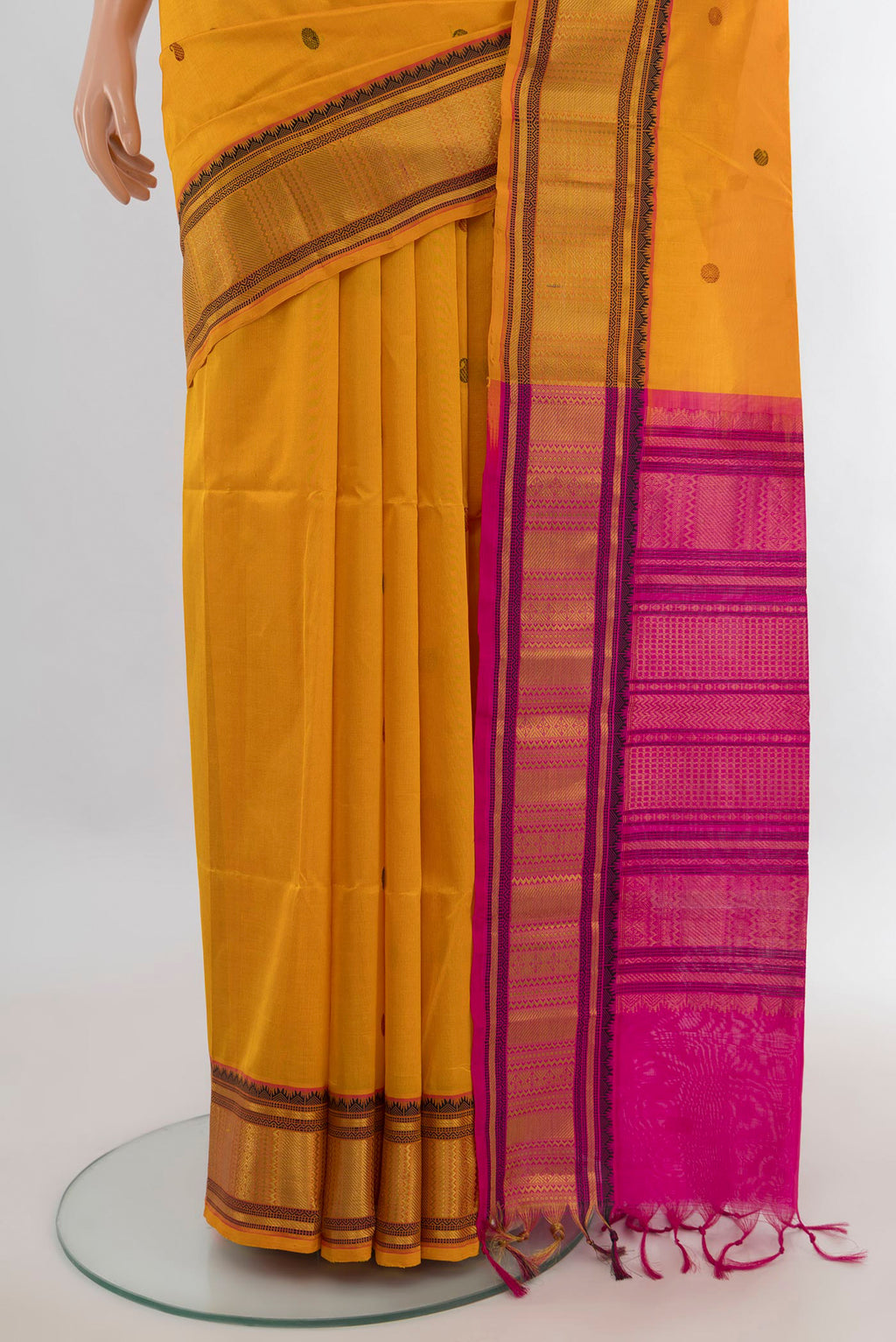 Pleats and pallu of Yellow Silk Cotton Saree with Thread Butta on the body and Zari Border. 