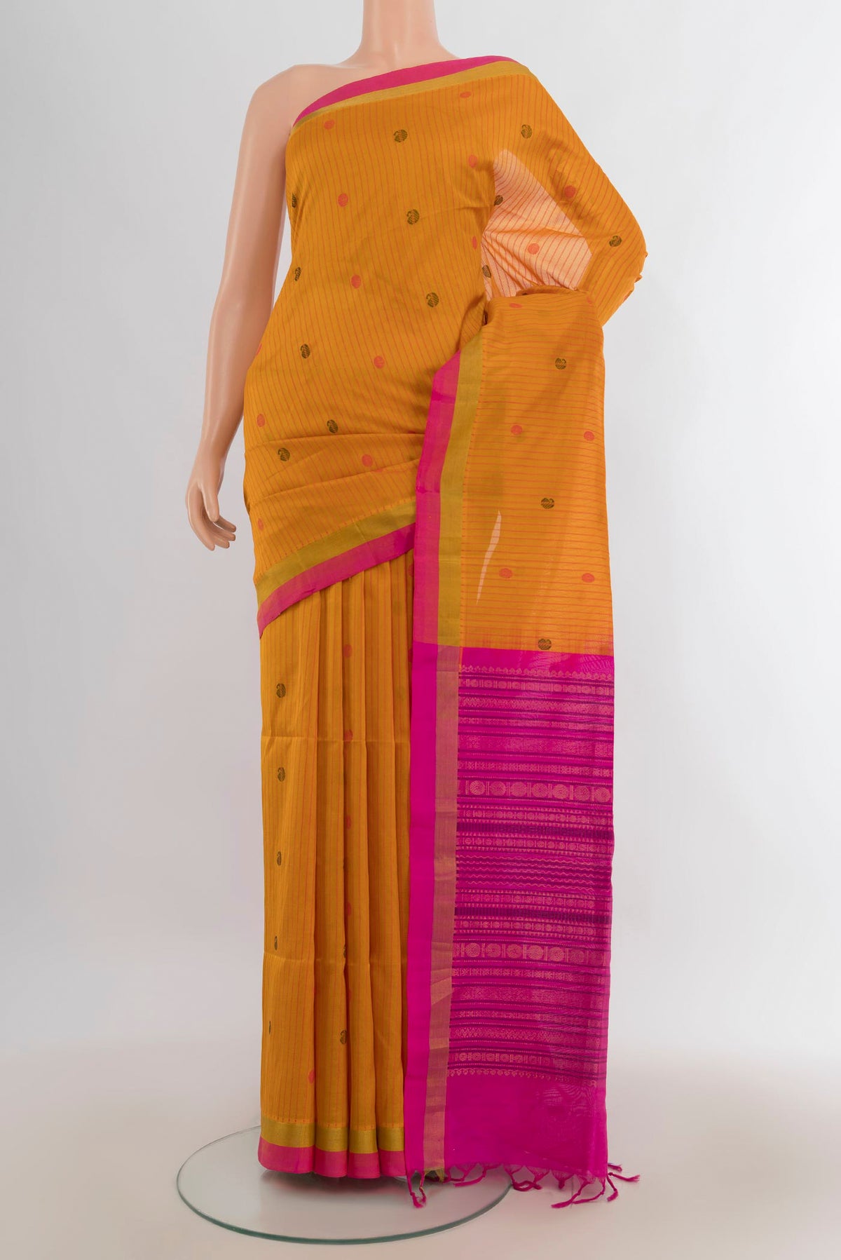 Yellow Silk Cotton Saree with Zari Butta on the body and Silk Border.  displayed on a mannequin