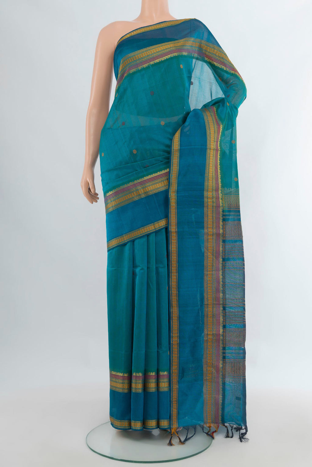 Light Blue Silk Cotton Saree with Thread Butta on the body and Thread Border.  displayed on a mannequin