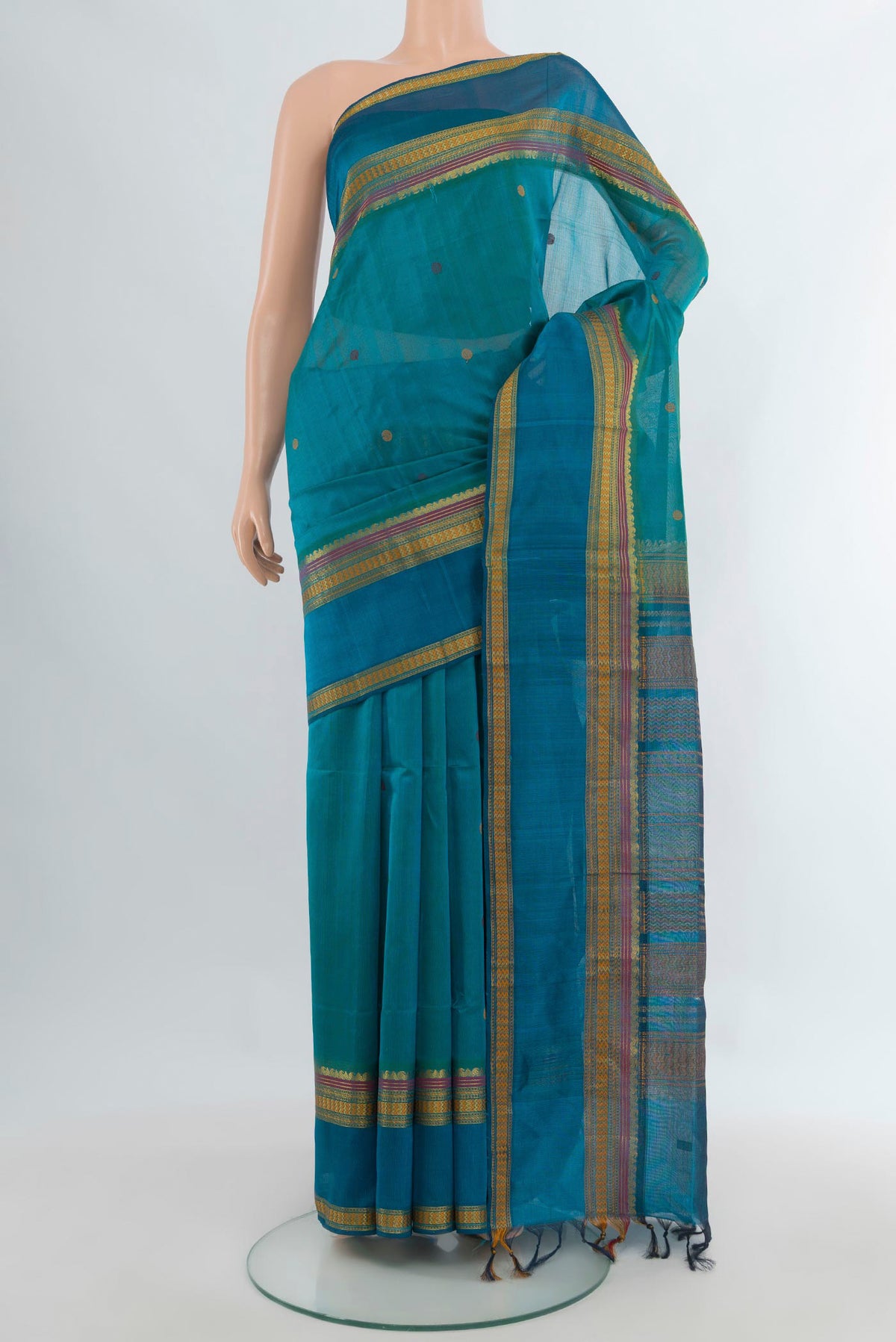 Light Blue Silk Cotton Saree with Thread Butta on the body and Thread Border.  displayed on a mannequin