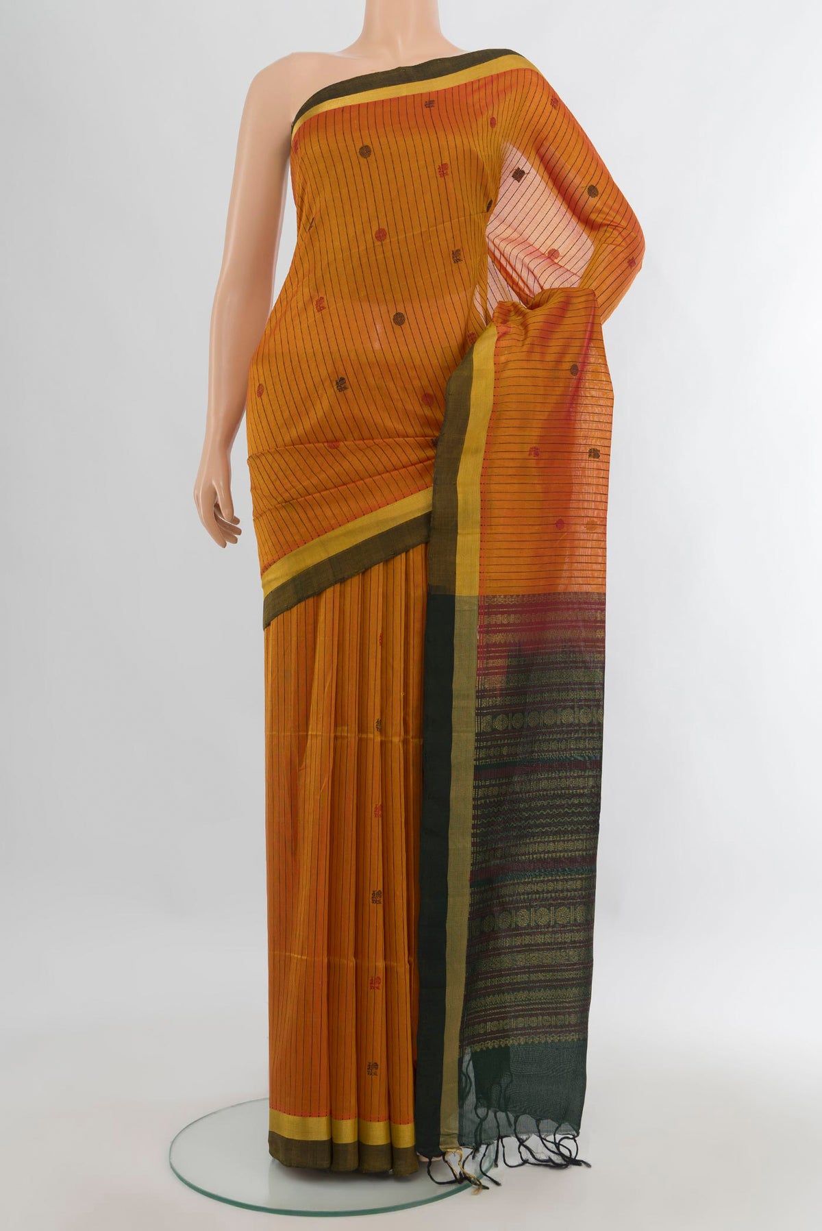 Mustard Silk Cotton Saree with Stripes on the body and Plain Border.  displayed on a mannequin