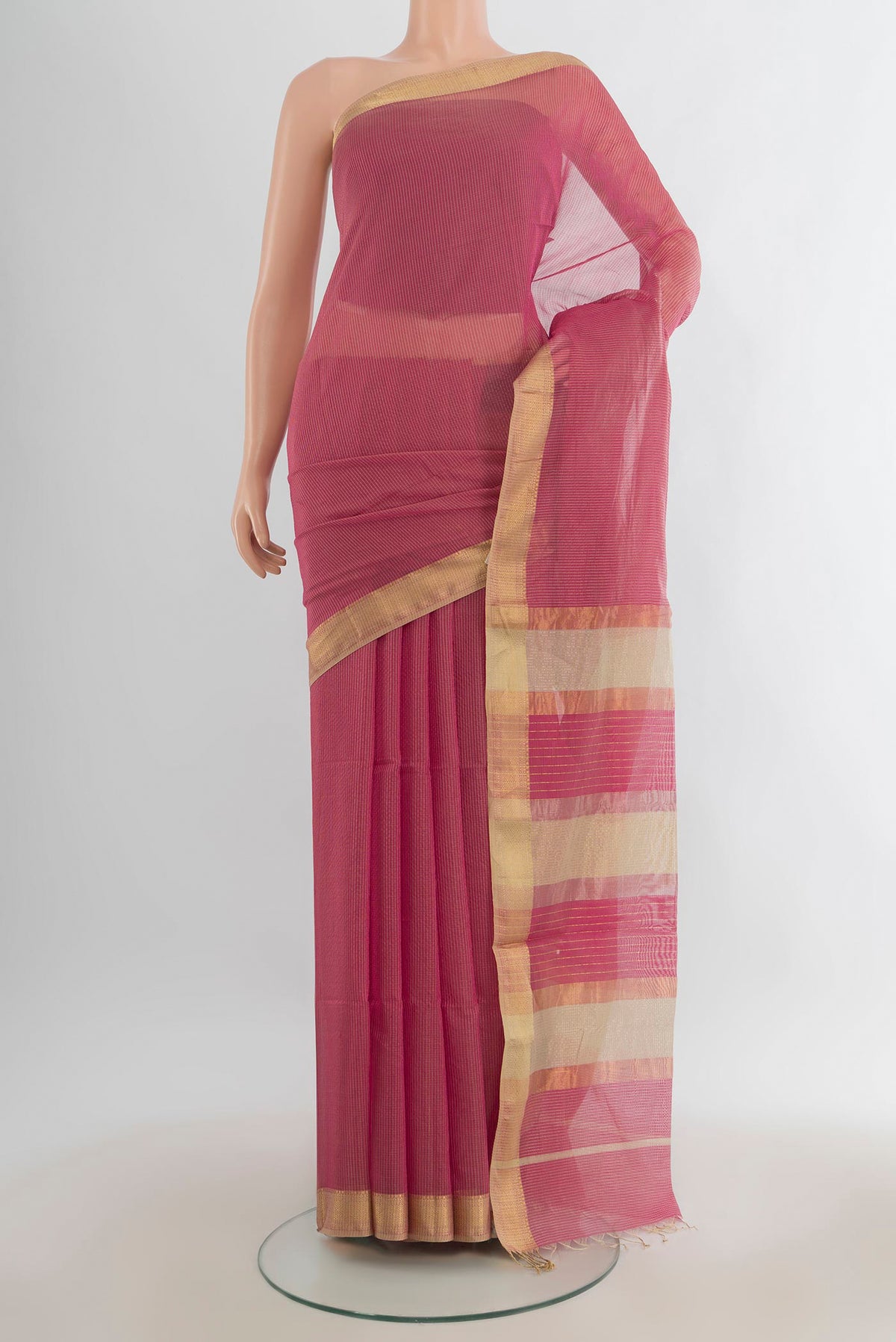Coral Maheshwari Cotton Saree with Checked design on the body and Zari Border.  displayed on a mannequin