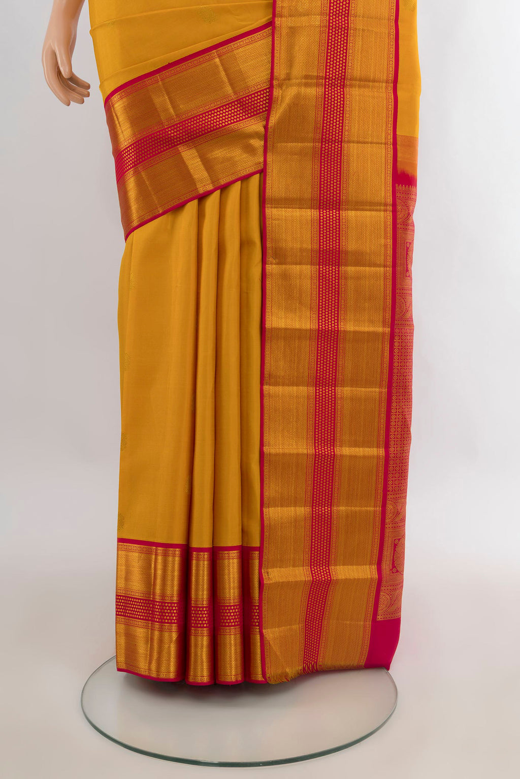 Pleats and pallu of Pure Silk Mustard Kanjivaram Saree with Zari Butta on the body and Zari Border. 