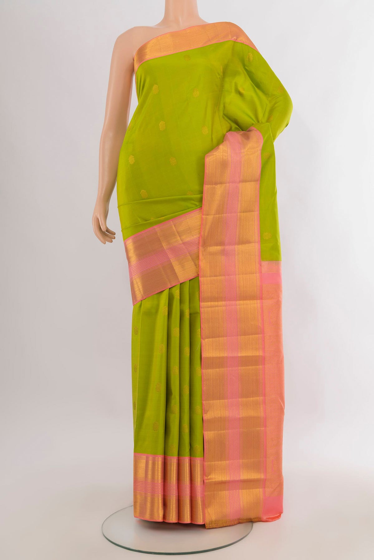 Pure Silk Parrot Green Kanjivaram Saree with Zari Butta on the body and Zari Border.  displayed on a mannequin