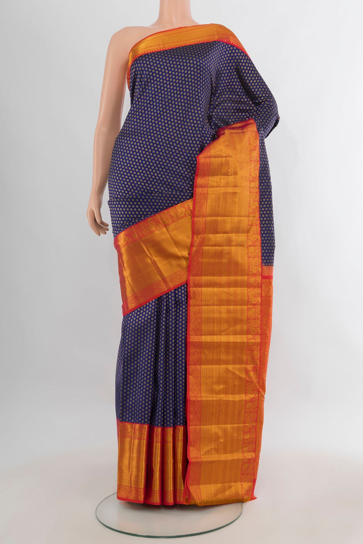 Pure Silk Navy Blue Kanjivaram Saree with Zari Butta on the body and Zari Border.  displayed on a mannequin