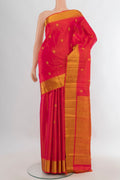 Pure Silk Orange Kanjivaram Saree with Zari Butta on the body and Zari Border.  displayed on a mannequin