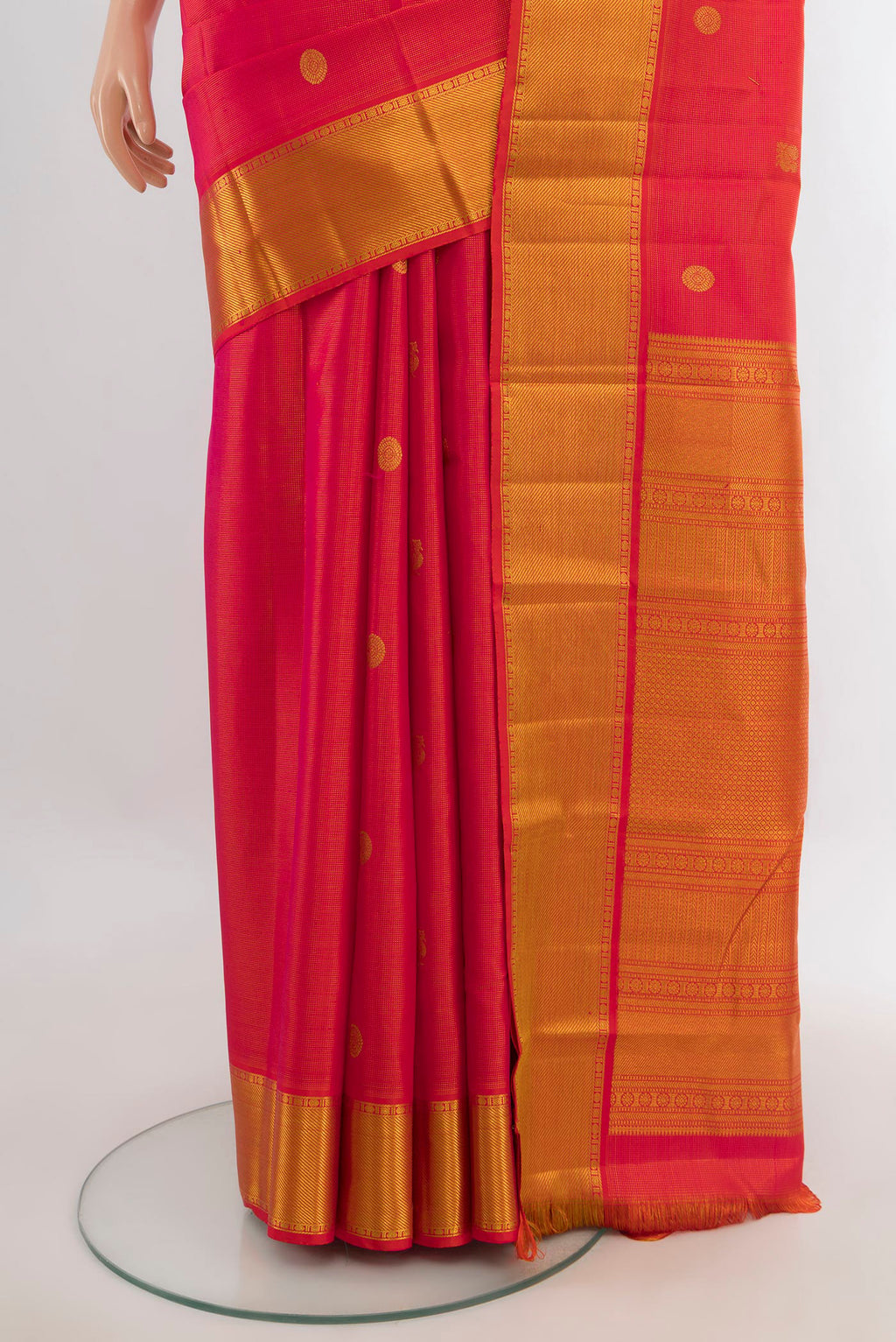 Pleats and pallu of Pure Silk Orange Kanjivaram Saree with Zari Butta on the body and Zari Border. 