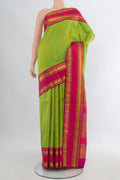 Pure Silk Parrot Green Kanchipuram Saree with Checked design on the body and Zari Border.  displayed on a mannequin