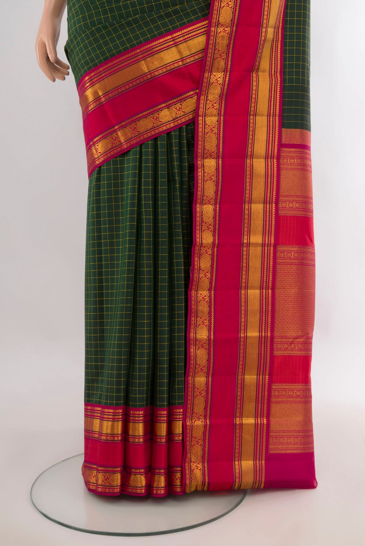 Pleats and pallu of Pure Silk Bottle Green Kanchipuram Saree with Checked design on the body and Zari Border. 