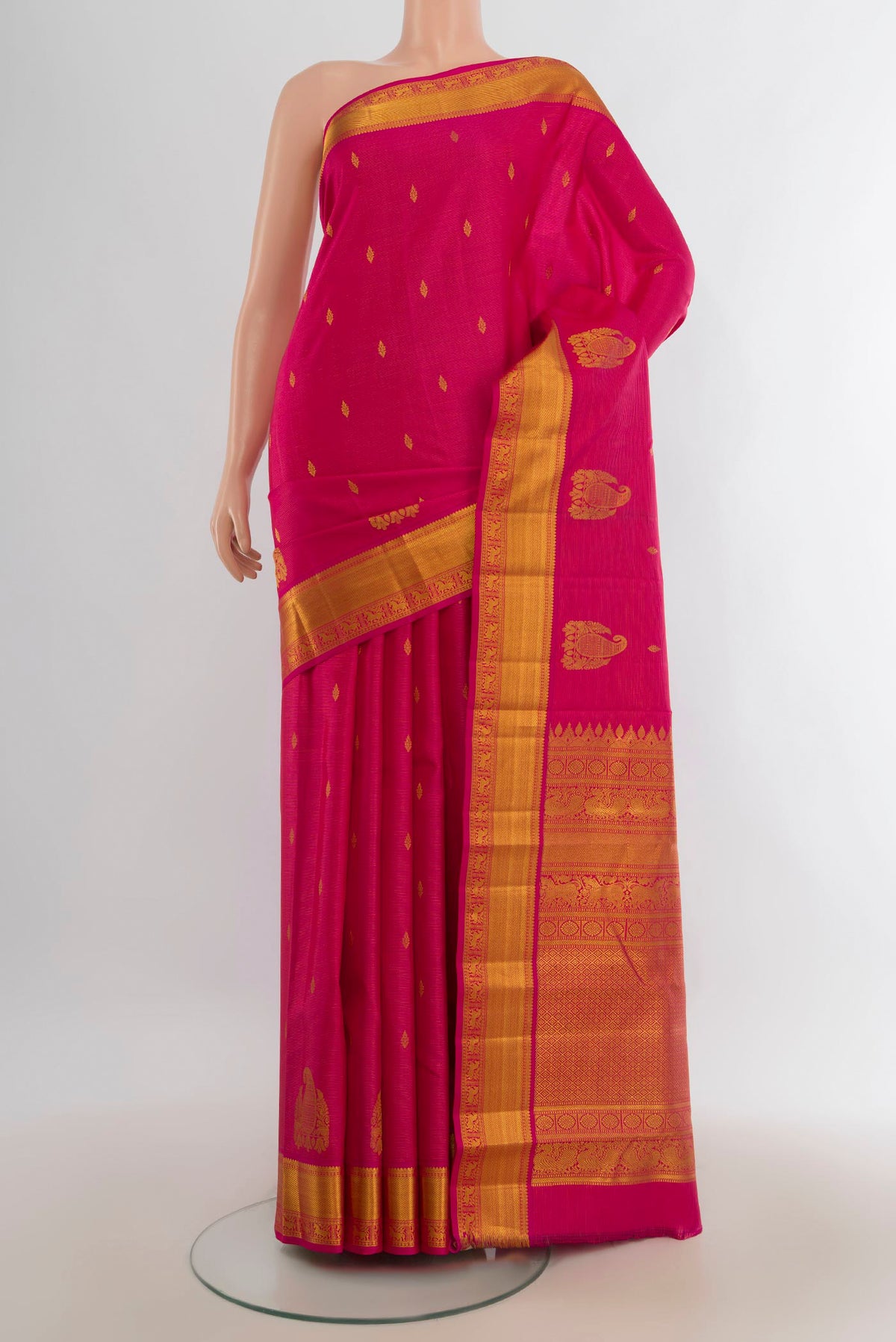 Pure Silk Rani Pink Kanchipuram Saree with Zari Butta on the body and Silk Border.  displayed on a mannequin