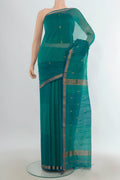 Turquoise Maheshwari Cotton Saree with Zari Butta on the body and Zari Border.  displayed on a mannequin