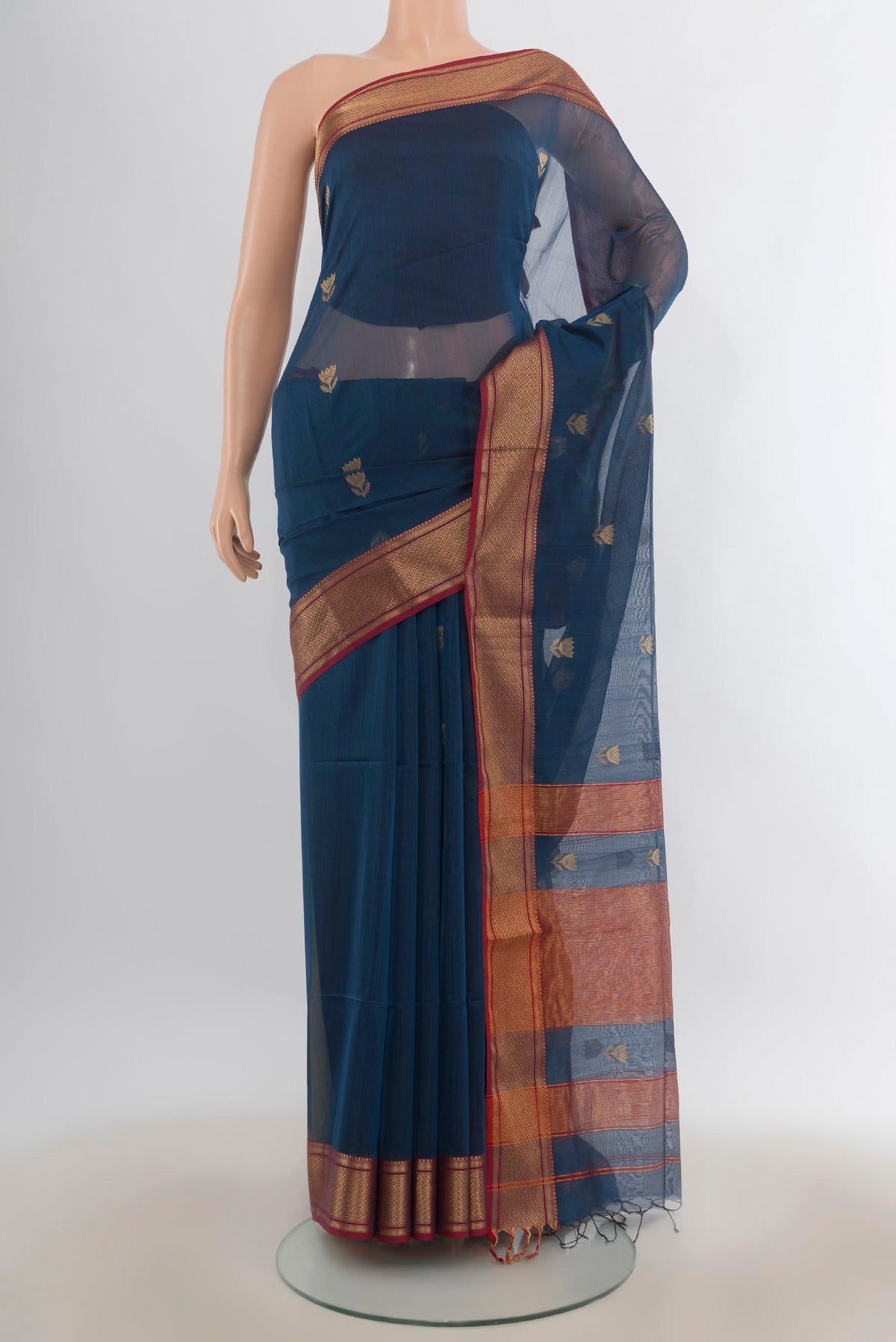 Peacock Blue Maheshwari Cotton Saree with Zari Butta on the body and Zari Border.  displayed on a mannequin