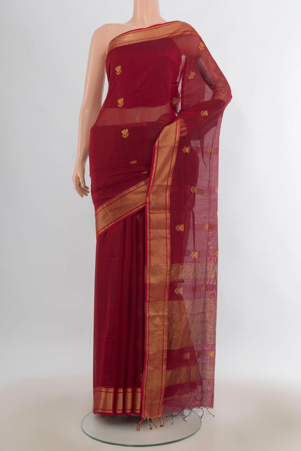 Maroon Maheshwari Cotton Saree with Zari Butta on the body and Zari Border.  displayed on a mannequin