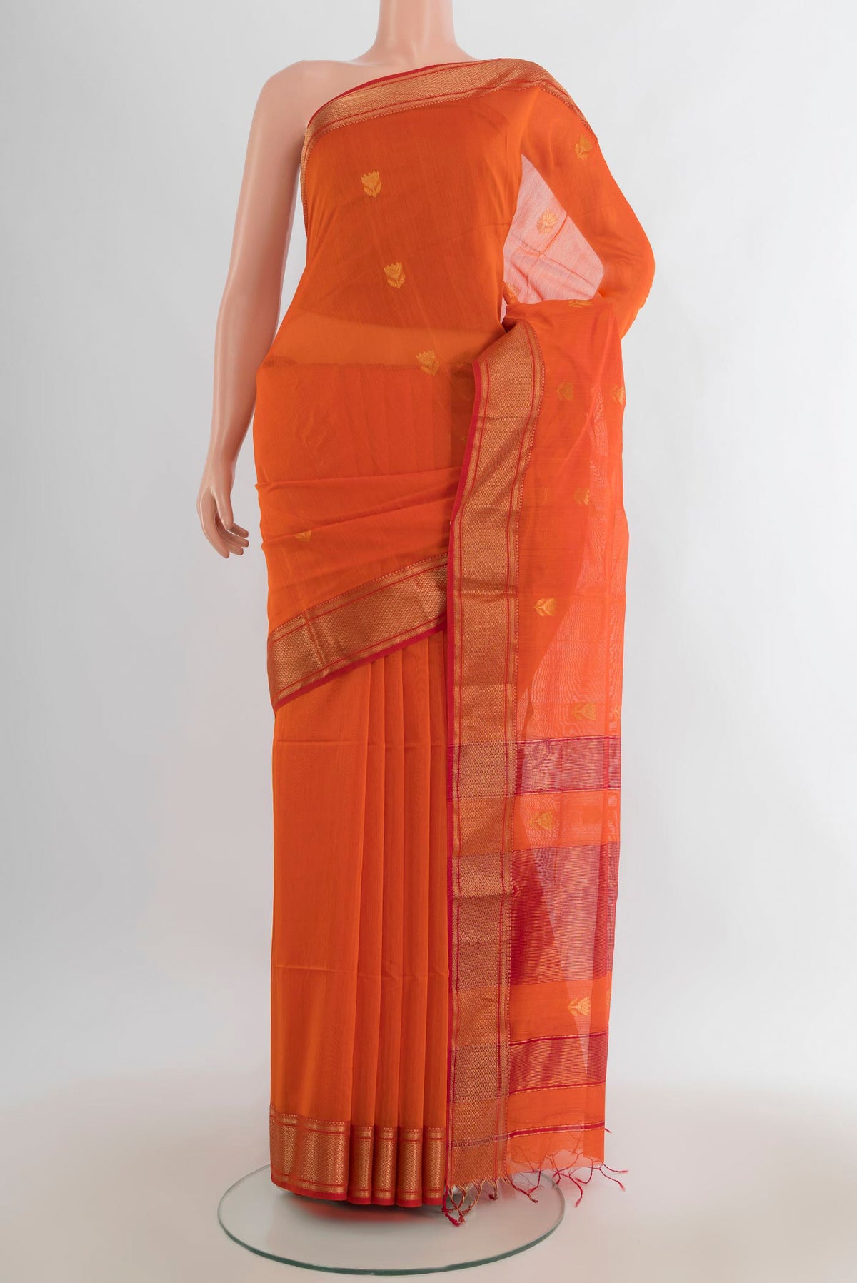 Orange Maheshwari Cotton Saree with Zari Butta on the body and Zari Border.  displayed on a mannequin