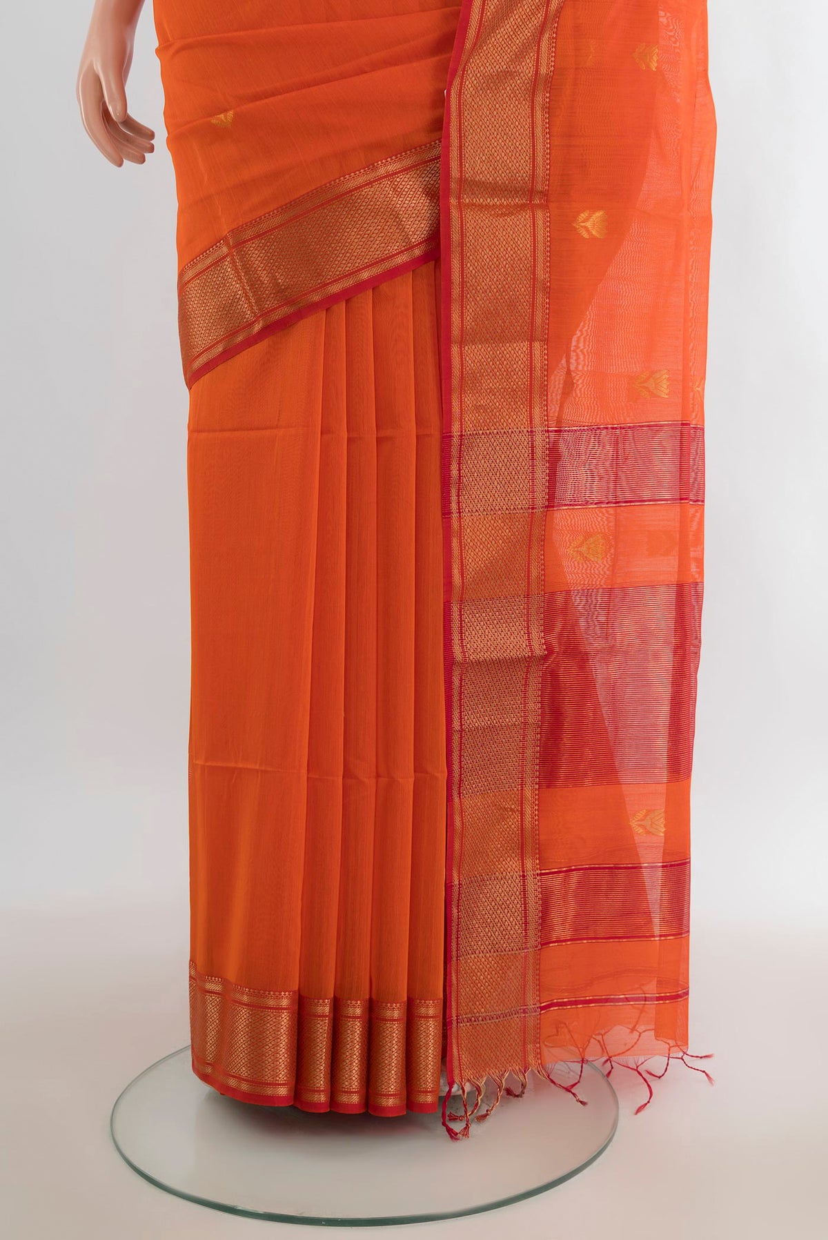 Pleats and pallu of Orange Maheshwari Cotton Saree with Zari Butta on the body and Zari Border. 