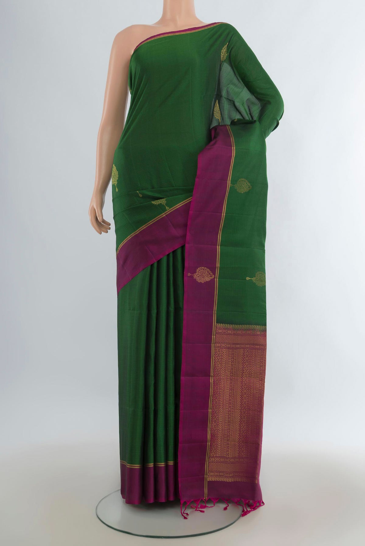 Pure Silk Green Soft Saree with Zari Butta on the body and Fancy Border.  displayed on a mannequin