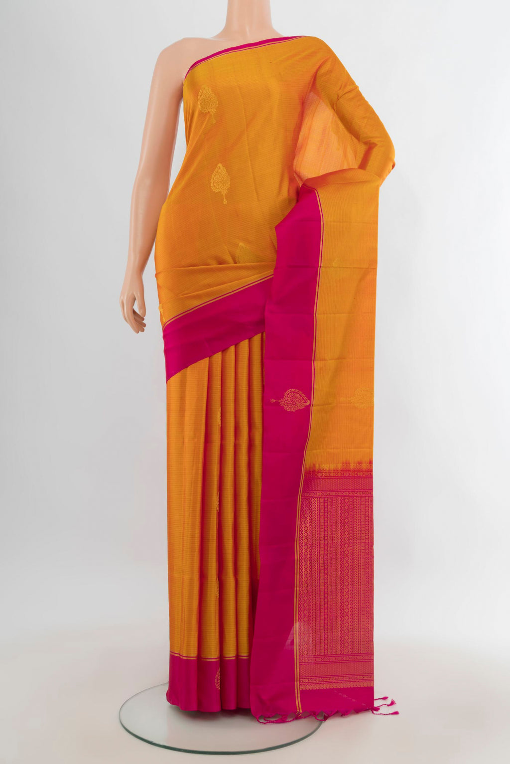 Pure Silk Mustard Soft Saree with Zari Butta on the body and Plain Border.  displayed on a mannequin