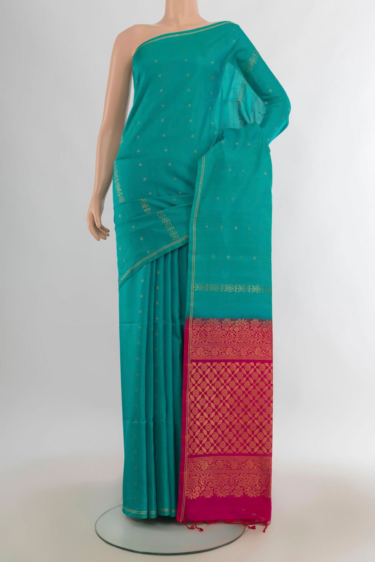 Pure Silk Turquoise Soft Saree with Zari Butta on the body and Zari Border.  displayed on a mannequin