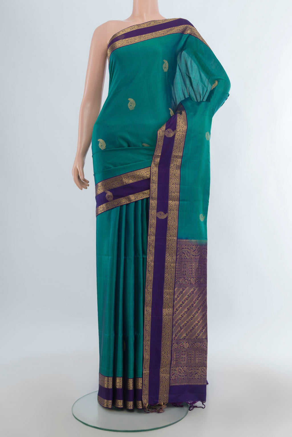 Pure Silk Green Soft Saree with Zari Butta on the body and Zari Border.  displayed on a mannequin