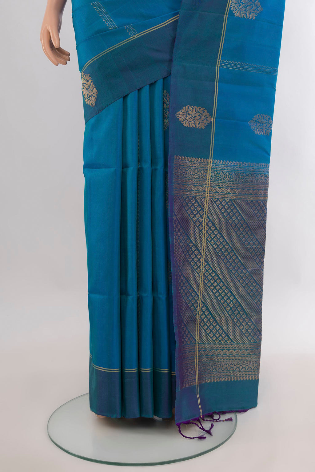 Pleats and pallu of Pure Silk Peacock Blue Soft Saree with Zari Butta on the body and Plain Border. 