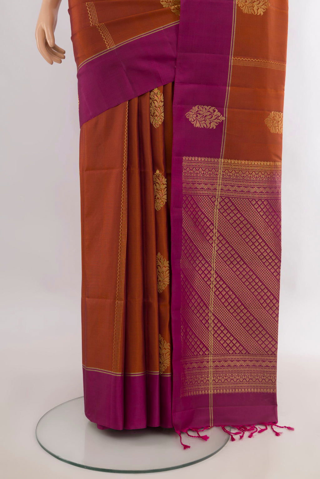 Pleats and pallu of Pure Silk Rust Soft Saree with Zari Butta on the body and Plain Border. 