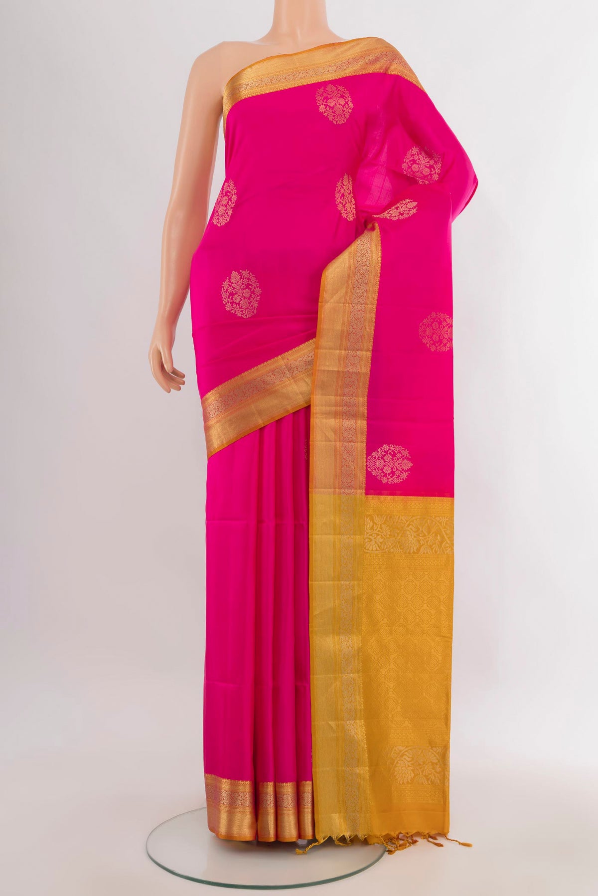 Pure Silk Rani Pink Soft Saree with Zari Butta on the body and Zari Border.  displayed on a mannequin