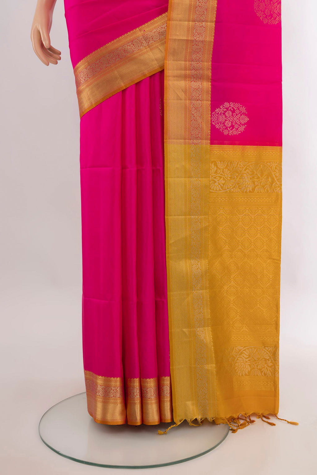 Pleats and pallu of Pure Silk Rani Pink Soft Saree with Zari Butta on the body and Zari Border. 