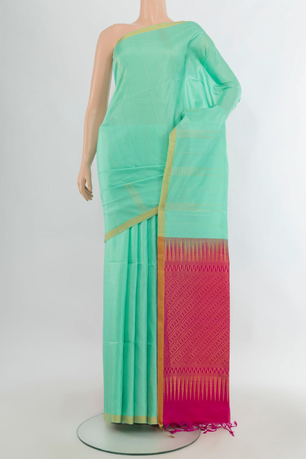 Pure Silk Mint Green Soft Saree with Zari Butta on the body and Zari Border.  displayed on a mannequin