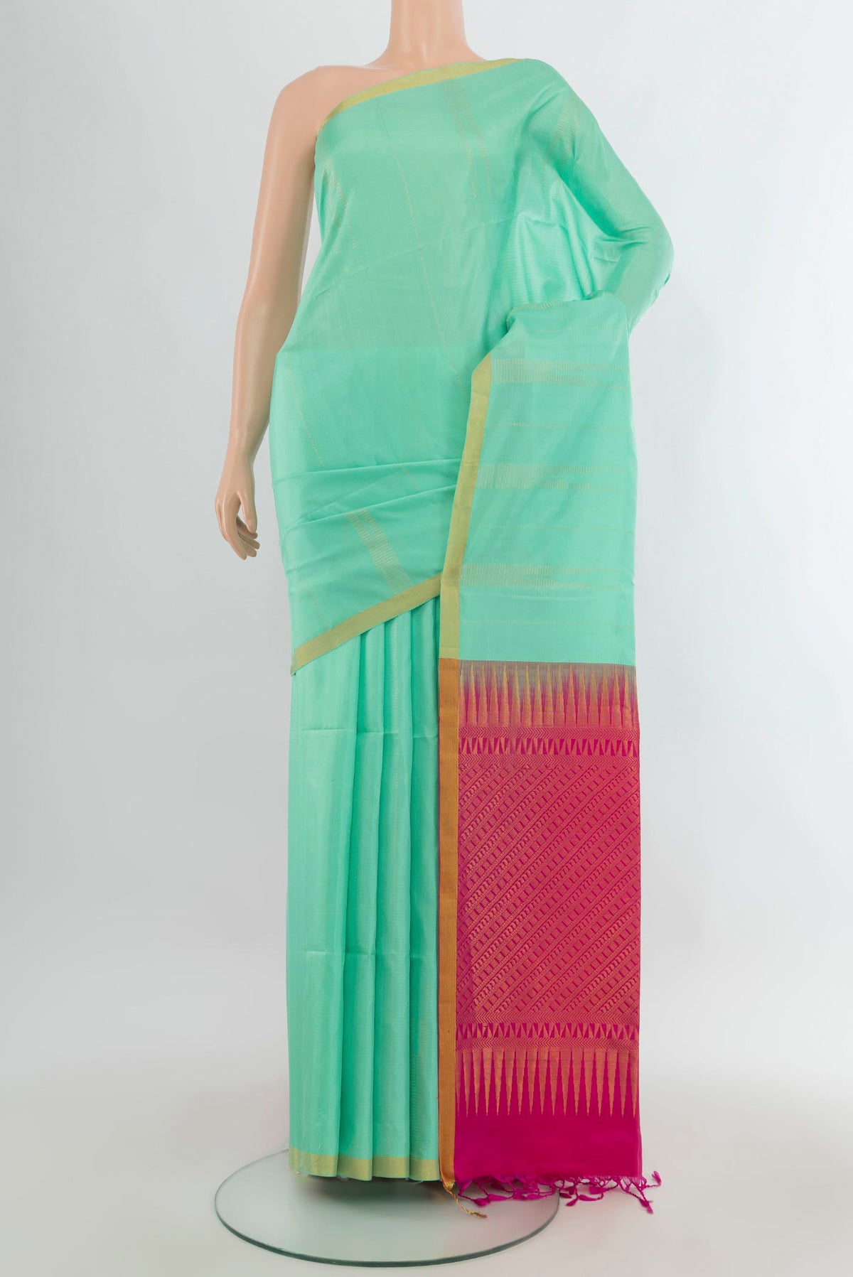 Pure Silk Mint Green Soft Saree with Zari Butta on the body and Zari Border.  displayed on a mannequin