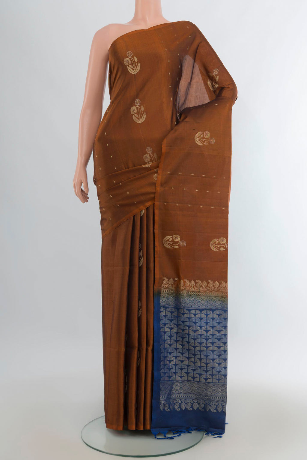 Pure Silk Rust Soft Saree with Zari Butta on the body and Without Border.  displayed on a mannequin