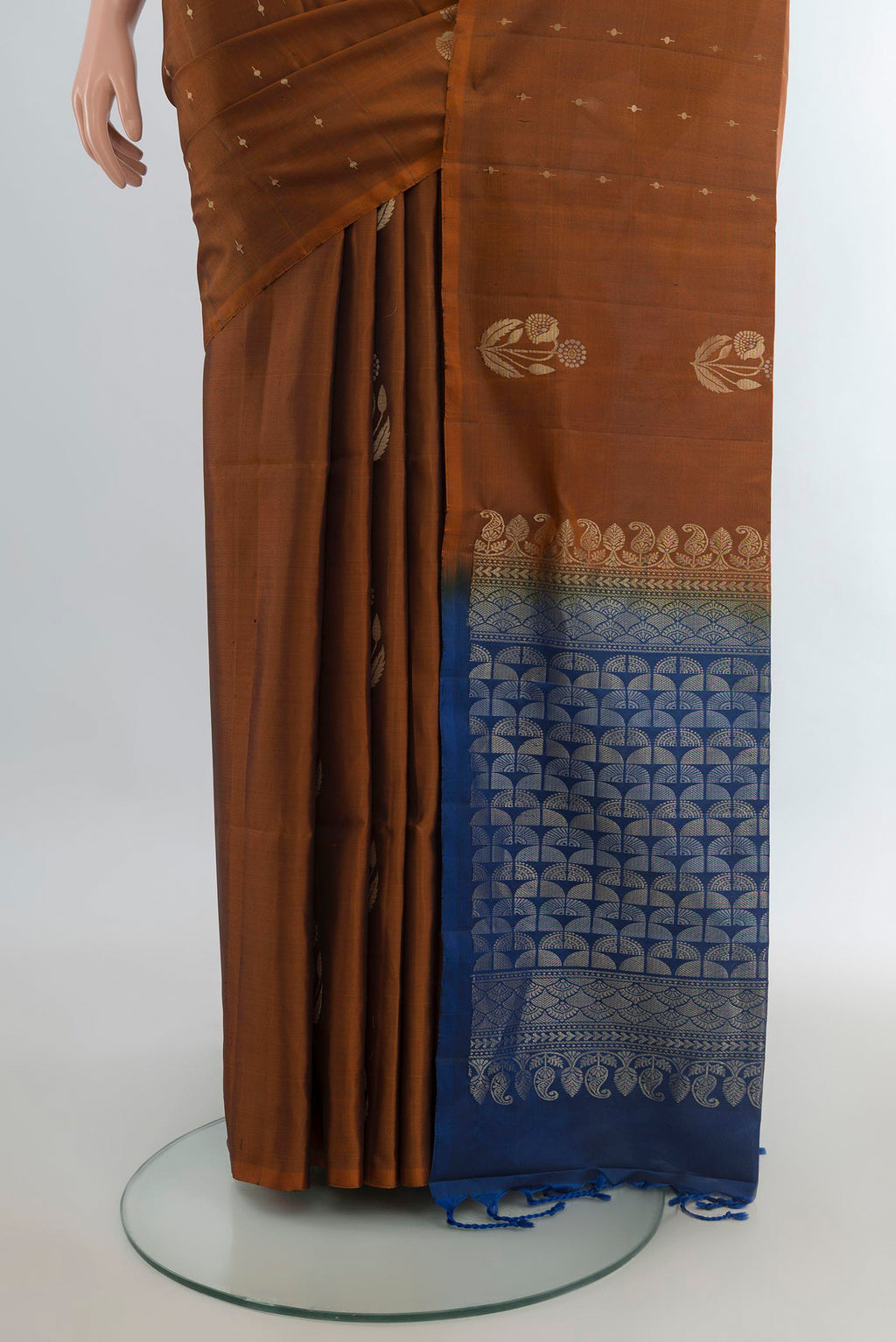 Pleats and pallu of Pure Silk Rust Soft Saree with Zari Butta on the body and Without Border. 