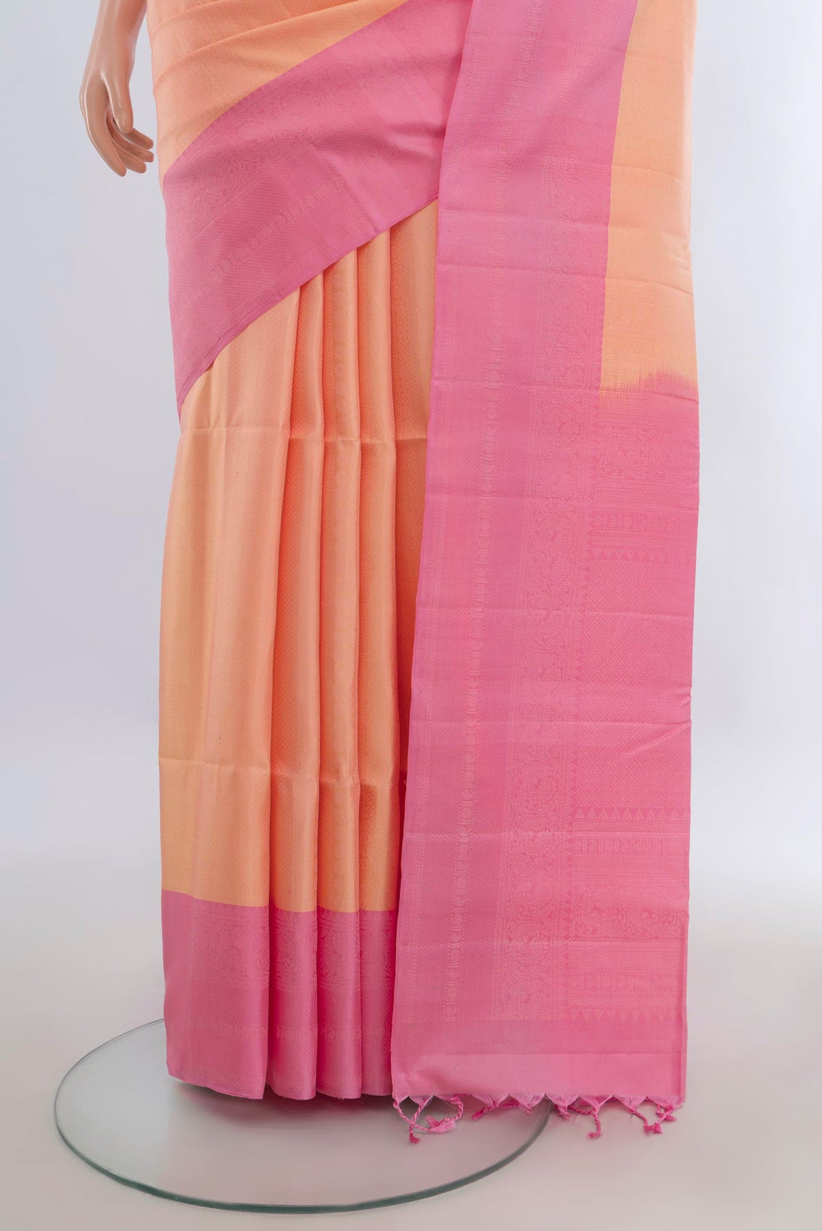 Pleats and pallu of Pure Silk Peach Soft Saree with Zari Butta on the body and Zari Border. 
