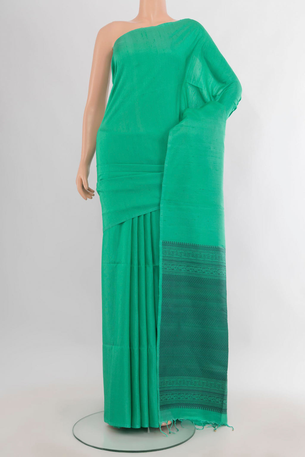 Pure Silk Green Soft Saree with Plain Body and Without Border.  displayed on a mannequin