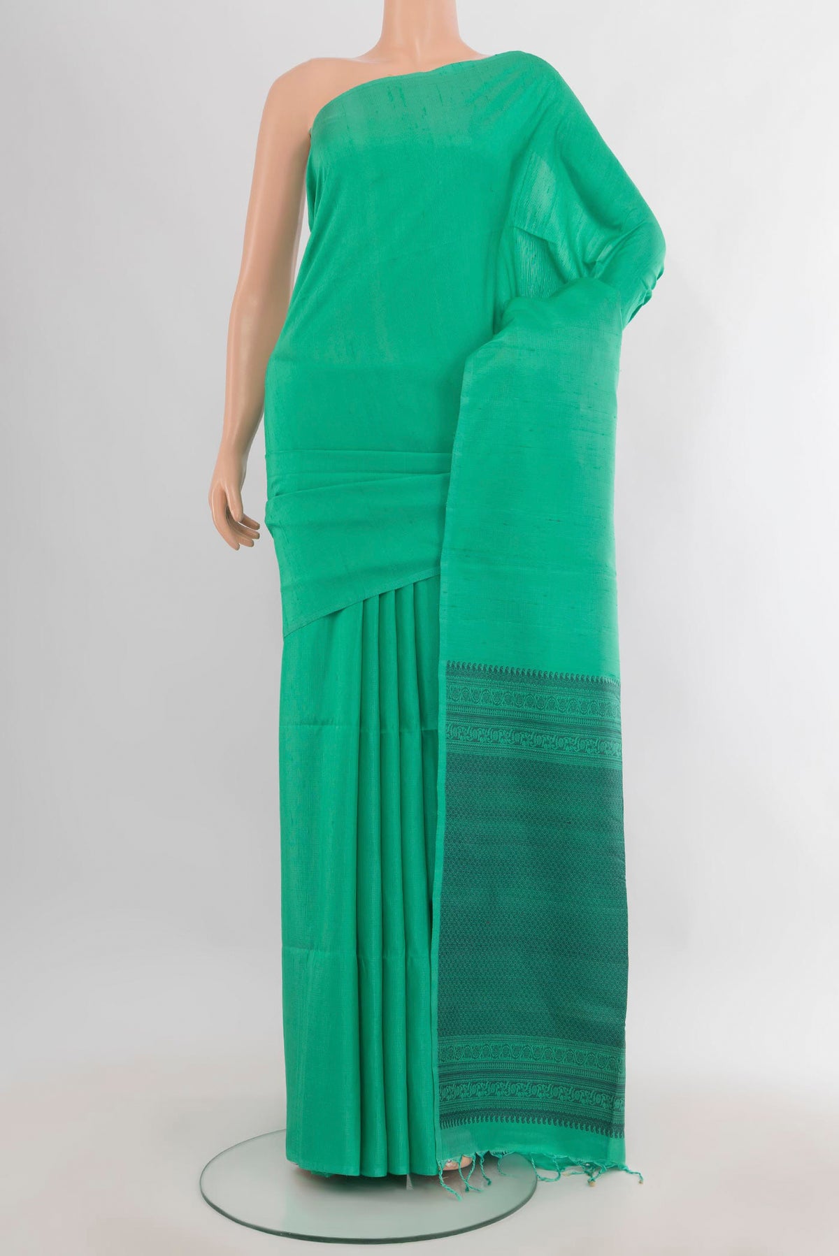 Pure Silk Green Soft Saree with Plain Body and Without Border.  displayed on a mannequin