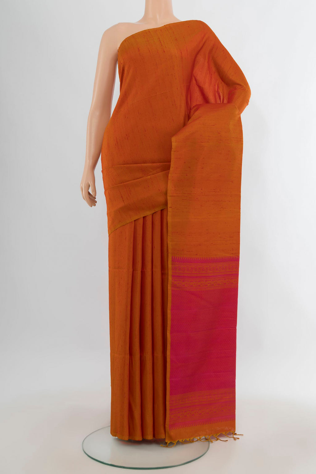 Pure Silk Rust Soft Saree with Plain Body and Without Border.  displayed on a mannequin