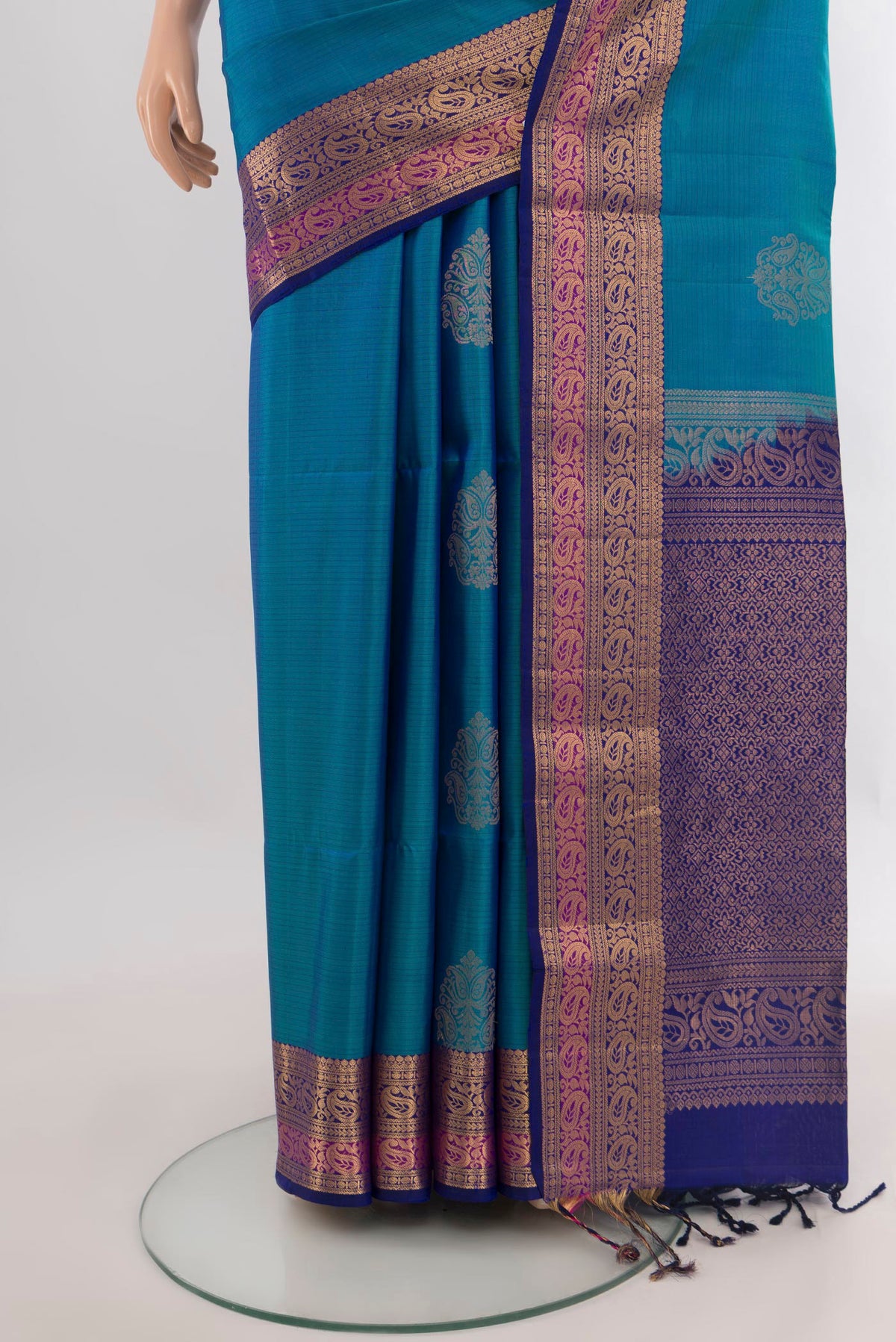 Pleats and pallu of Pure Silk Peacock Blue Soft Saree with Zari Butta on the body and Zari Border. 