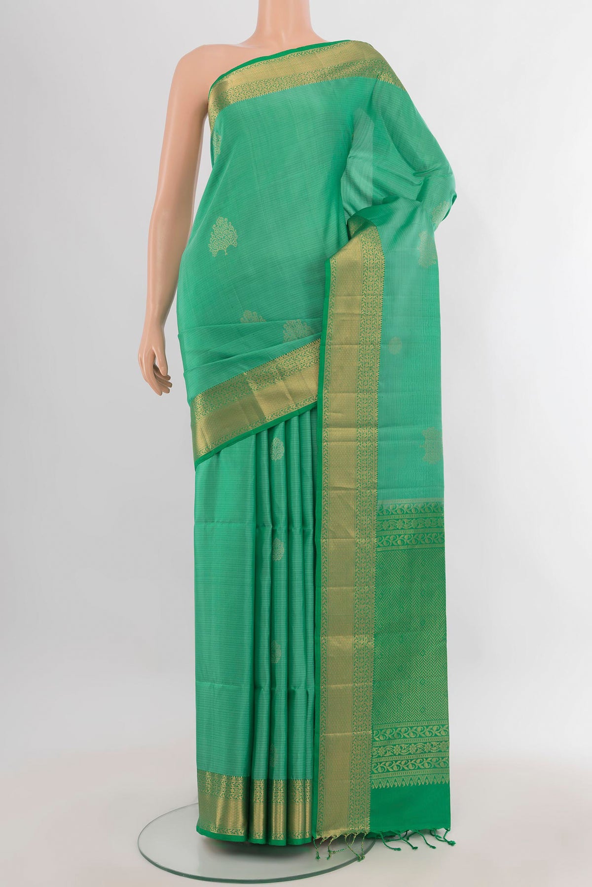 Pure Silk Light Green Soft Saree with Zari Butta on the body and Zari Border.  displayed on a mannequin