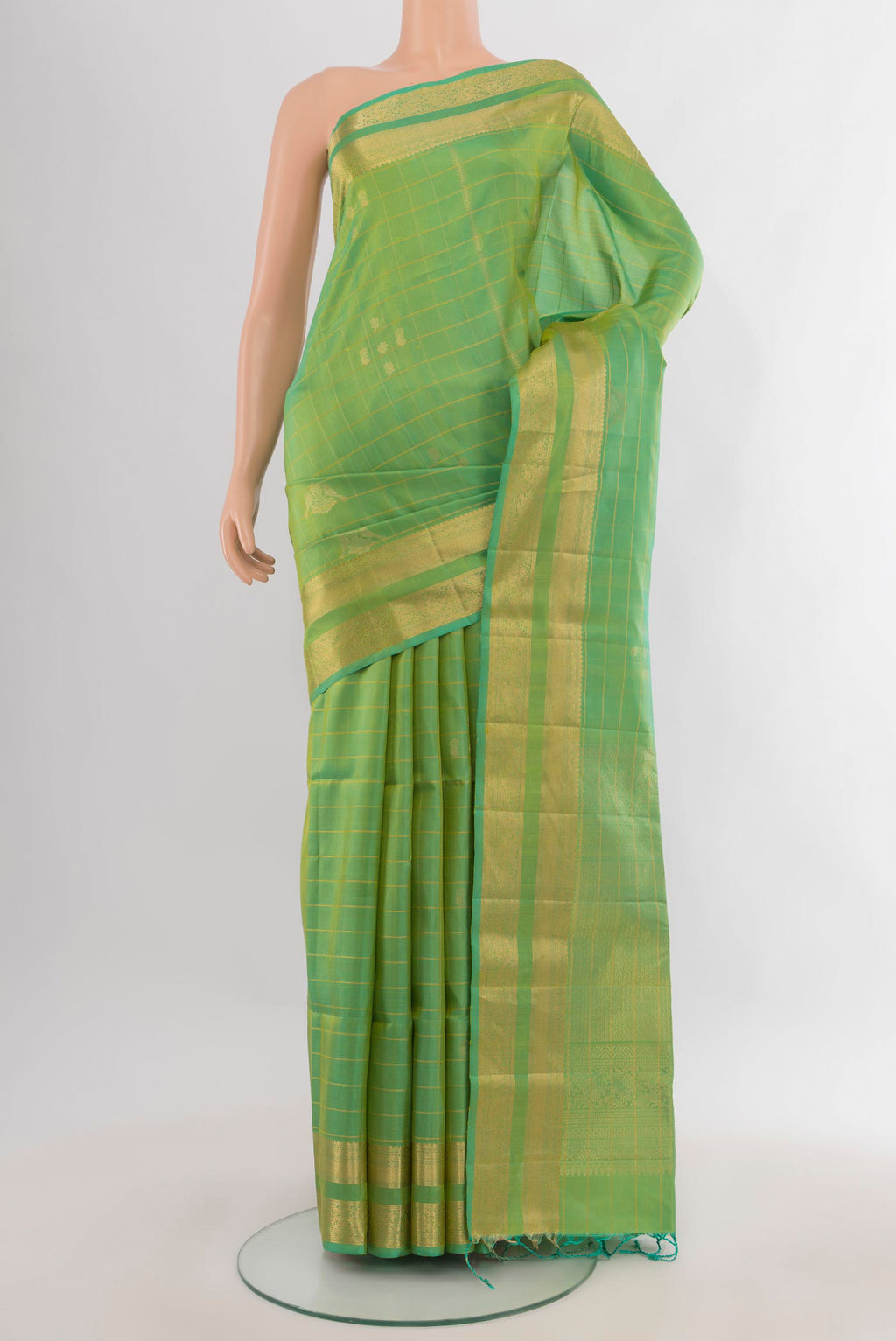 Pure Silk Light Green Soft Saree with Checked design on the body and Zari Border.  displayed on a mannequin