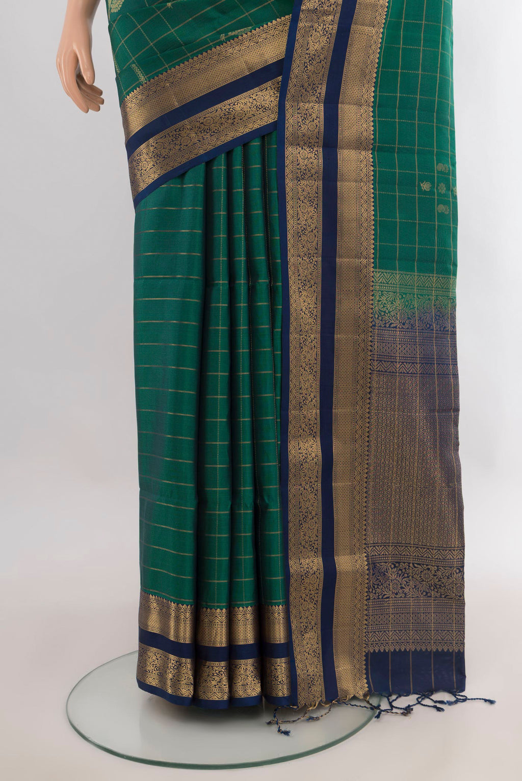 Pleats and pallu of Pure Silk Green Soft Saree with Checked design on the body and Zari Border. 