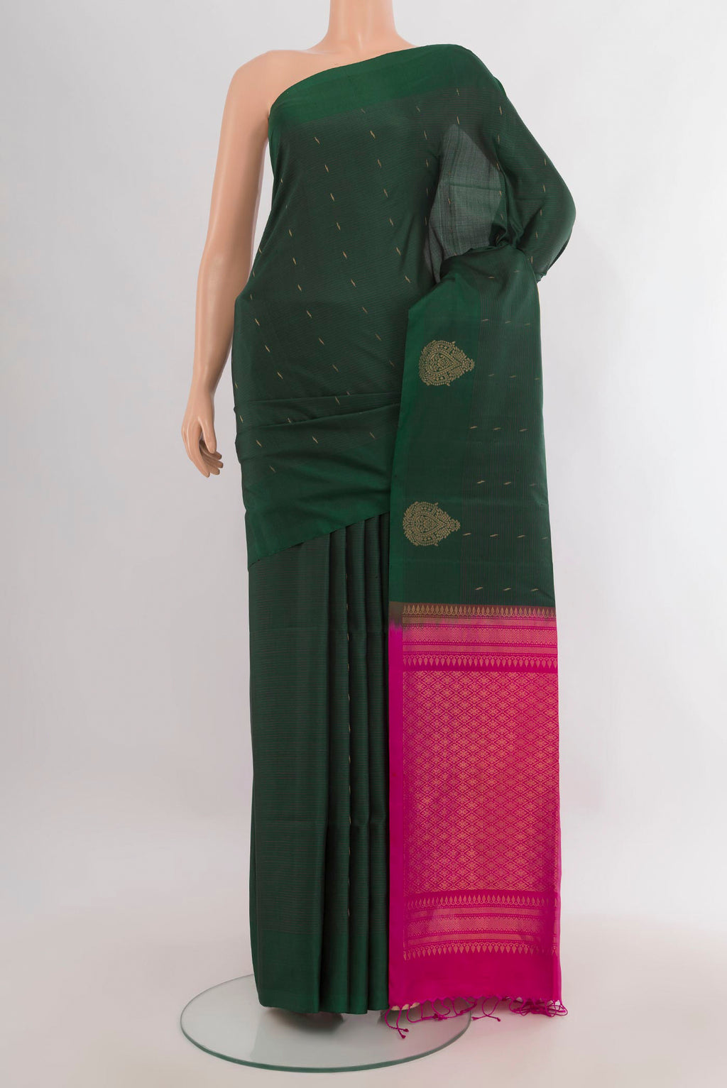 Pure Silk Bottle Green Soft Saree with Zari Butta on the body and Without Border.  displayed on a mannequin